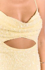 Close-up of the yellow sequin cowl neck and side cutout detail of the maxi dress