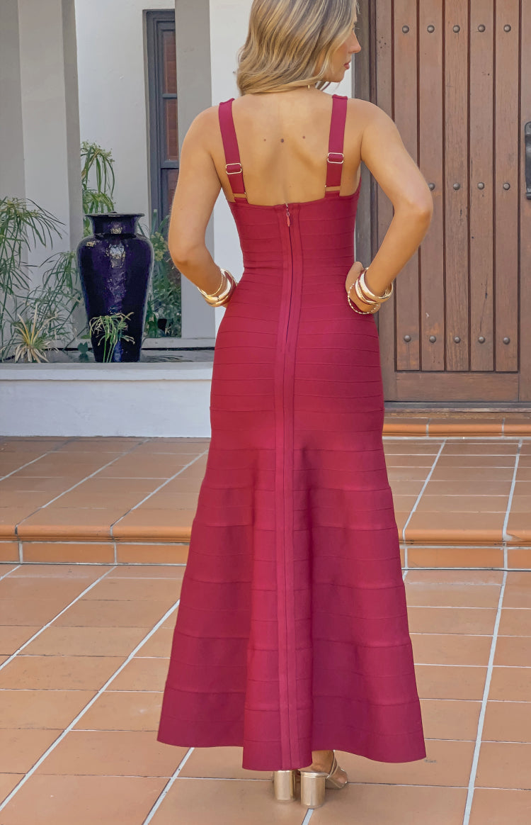 Back view of a burgundy bandage maxi dress showing the square back, thick straps, and exposed zipper