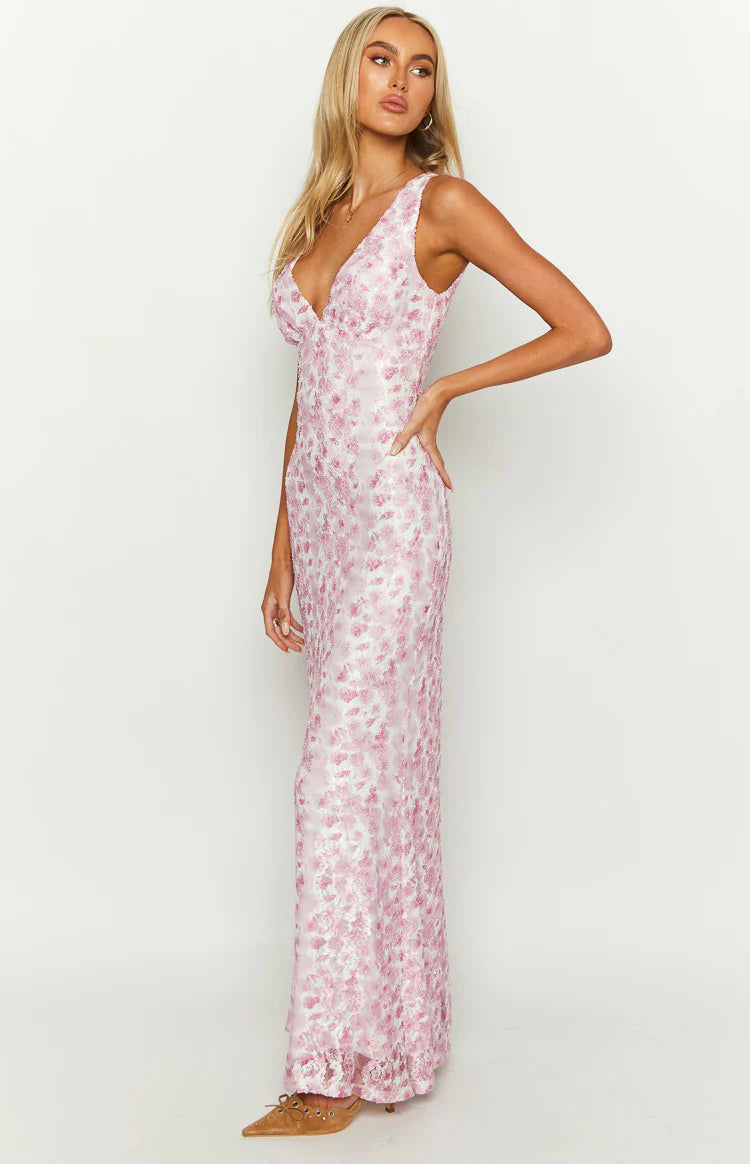 Side view of a fitted pink floral lace maxi dress, showing the full length of the intricate pattern