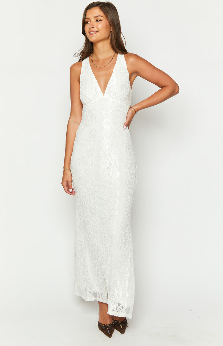 White lace maxi dress with a deep V-neck, fitted bodice, and flowing skirt