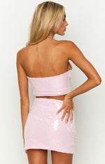 Rear view of a pink sequin halter top with a strapless back and cropped hem