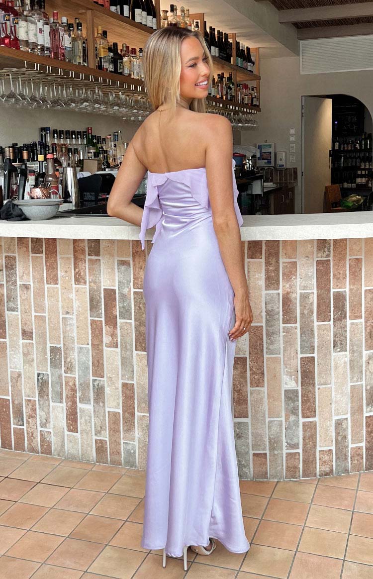 Rear view of a purple satin strapless maxi dress with ruffle detailing across the back bodice