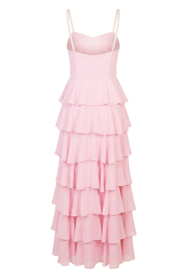 Rear view of a pink maxi dress with pearl straps and a full tiered ruffle skirt