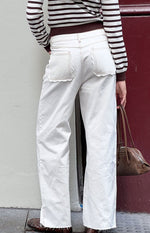 Beginning Boutique Felix Scallop Edge White Denim Jeans white denim jeans with scallop edge back pockets, raw hem, and contrast stitching