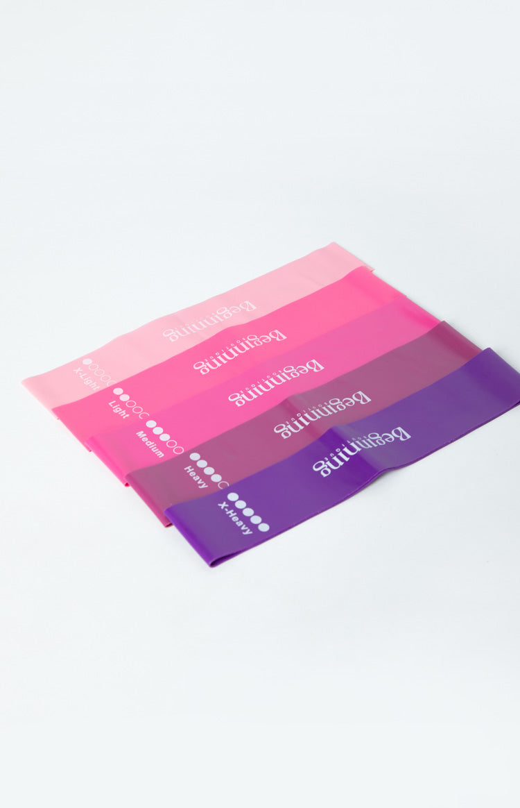 Set of five resistance bands in shades of pink and purple, with resistance levels from X-Light to X-Heavy