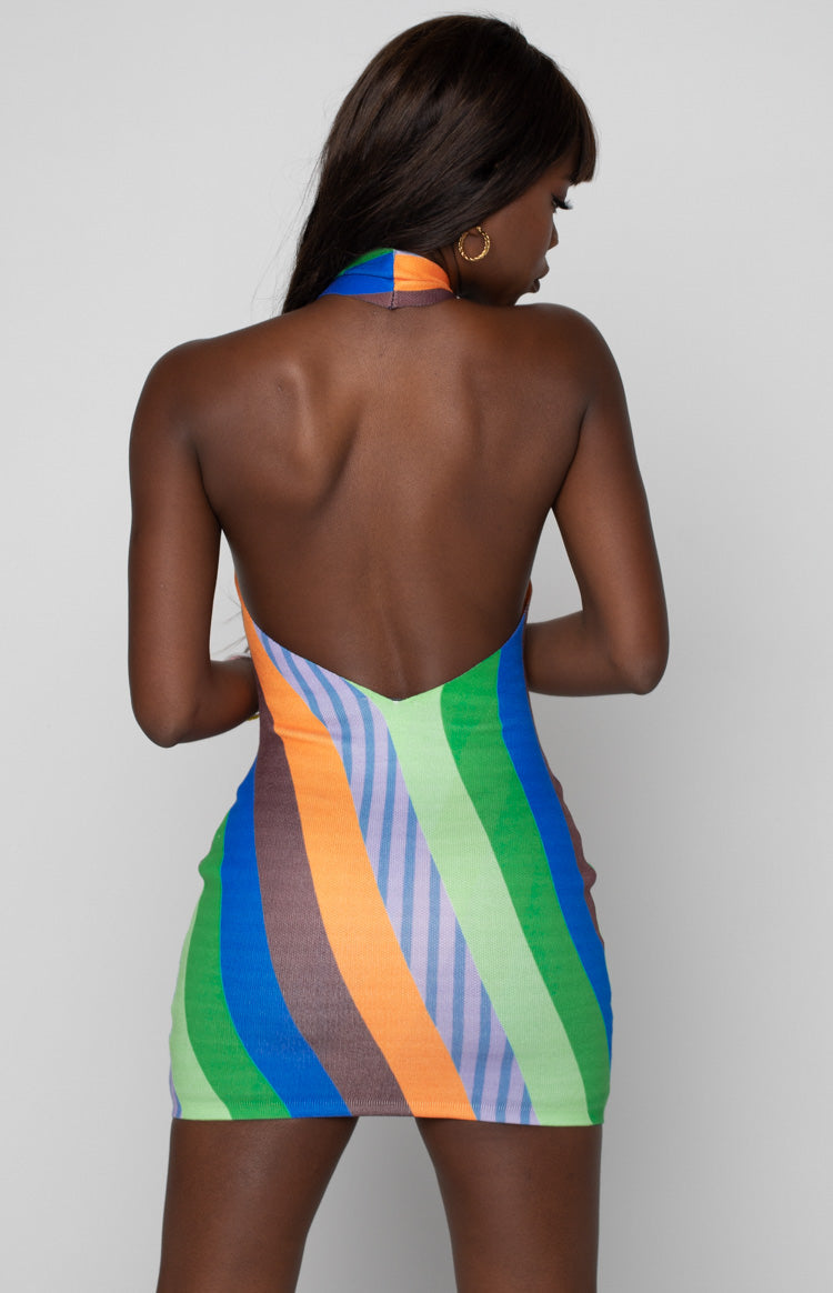 Side view of the multi-coloured striped halter dress, showing the criss-cross neckline and open side detail