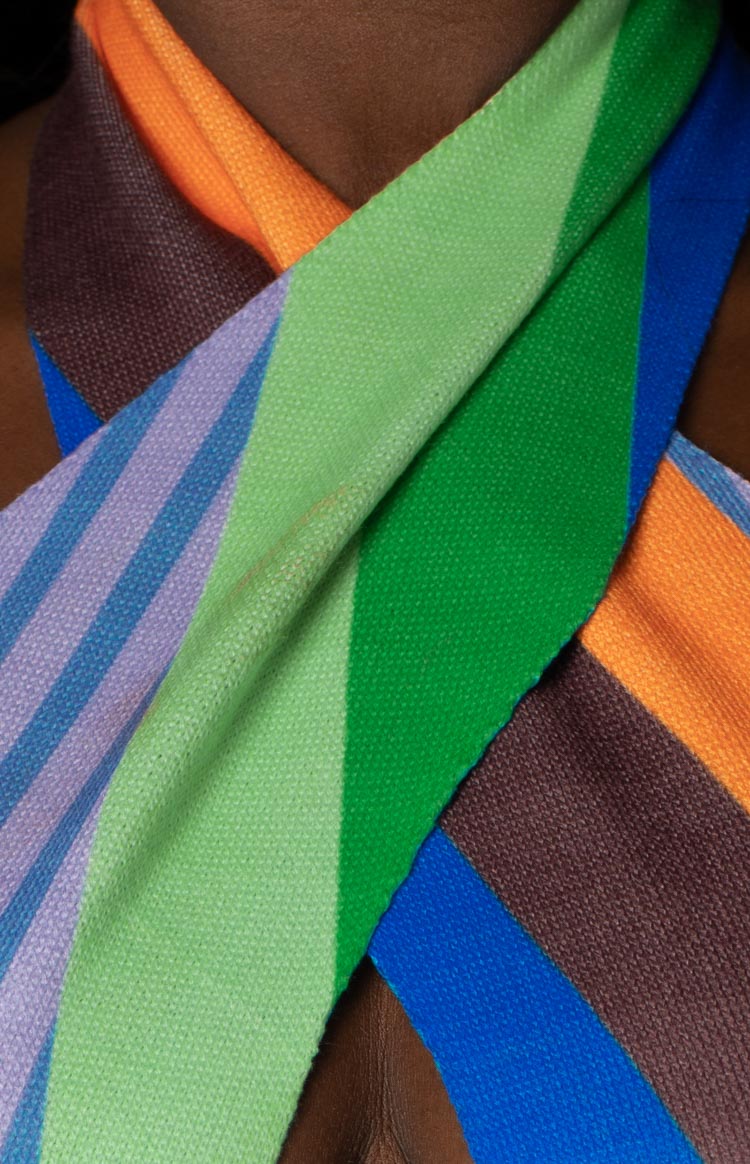 Close-up of the multi-coloured striped knit halter dress with a criss-cross neckline and keyhole cutout