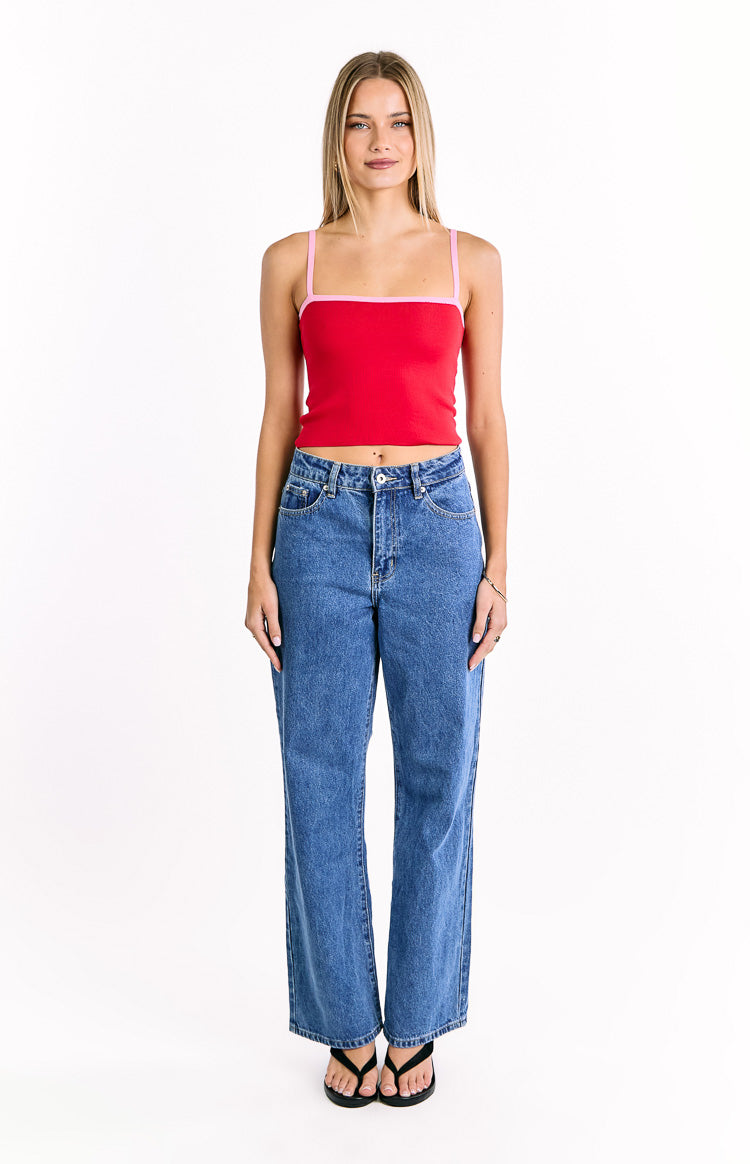 Front view of a red cropped knit top with thin pink spaghetti straps and a pink square neckline trim