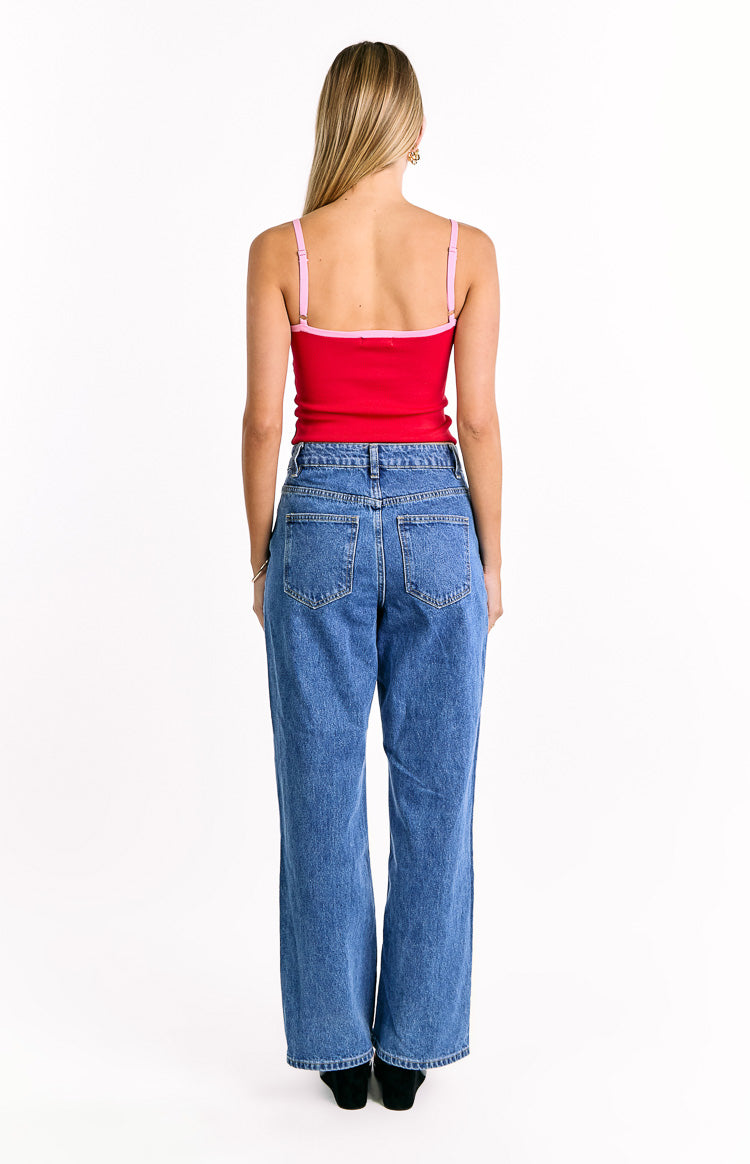 Rear view of the red ribbed knit top with thin adjustable pink spaghetti straps and pink trim