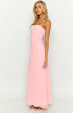 Front view of a pink maxi dress with a straight neckline, ruched bust, thin spaghetti straps, and side tie detail