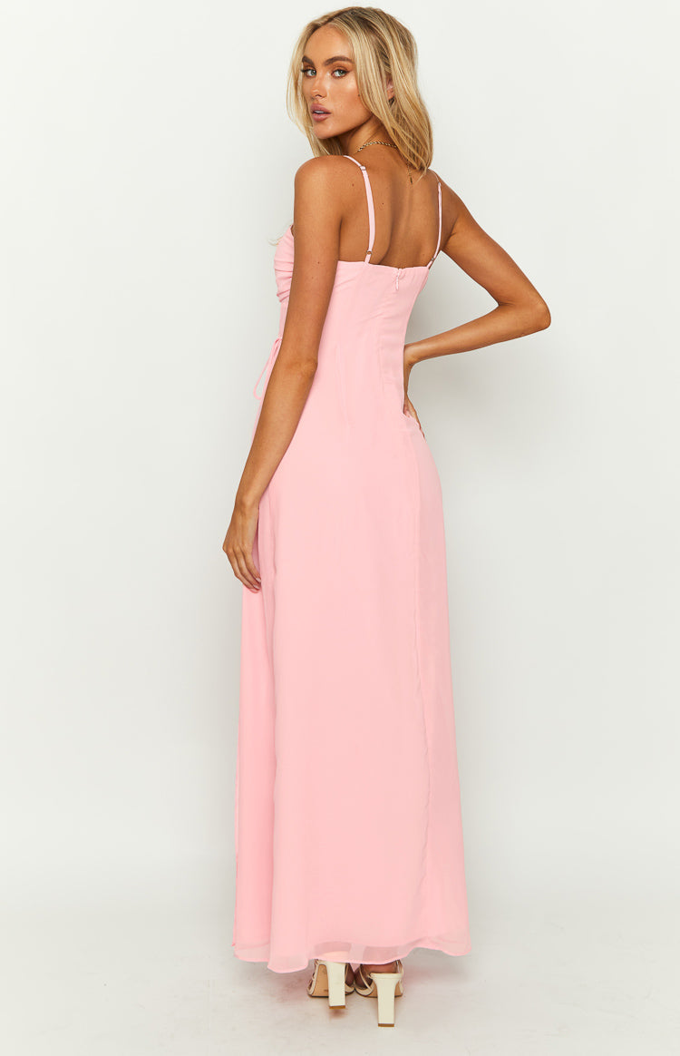 Rear-side view of a pink maxi dress showing thin spaghetti straps, a low back, invisible zipper, and side ruching