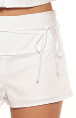 Close-up of the white tie-wrap detail and wide waistband on the side of the shorts