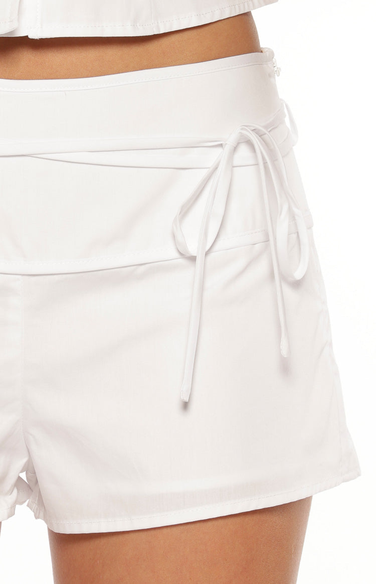 Close-up of the white tie-wrap detail and wide waistband on the side of the shorts