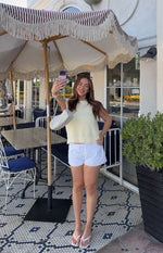 White relaxed fit mini shorts with a front tie waist, casual
