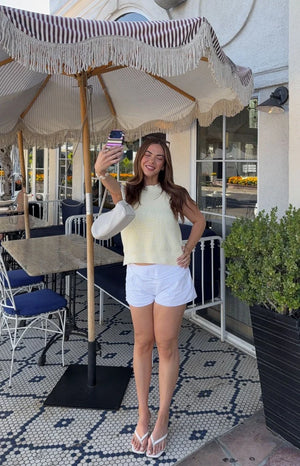 White relaxed fit mini shorts with a front tie waist, casual