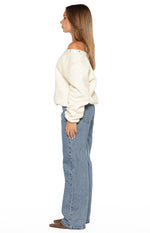 Side view of mid wash denim jeans with a relaxed straight leg fit and full length hem