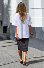 Rear view of a black organza sheer midi skirt with a straight, structured fit