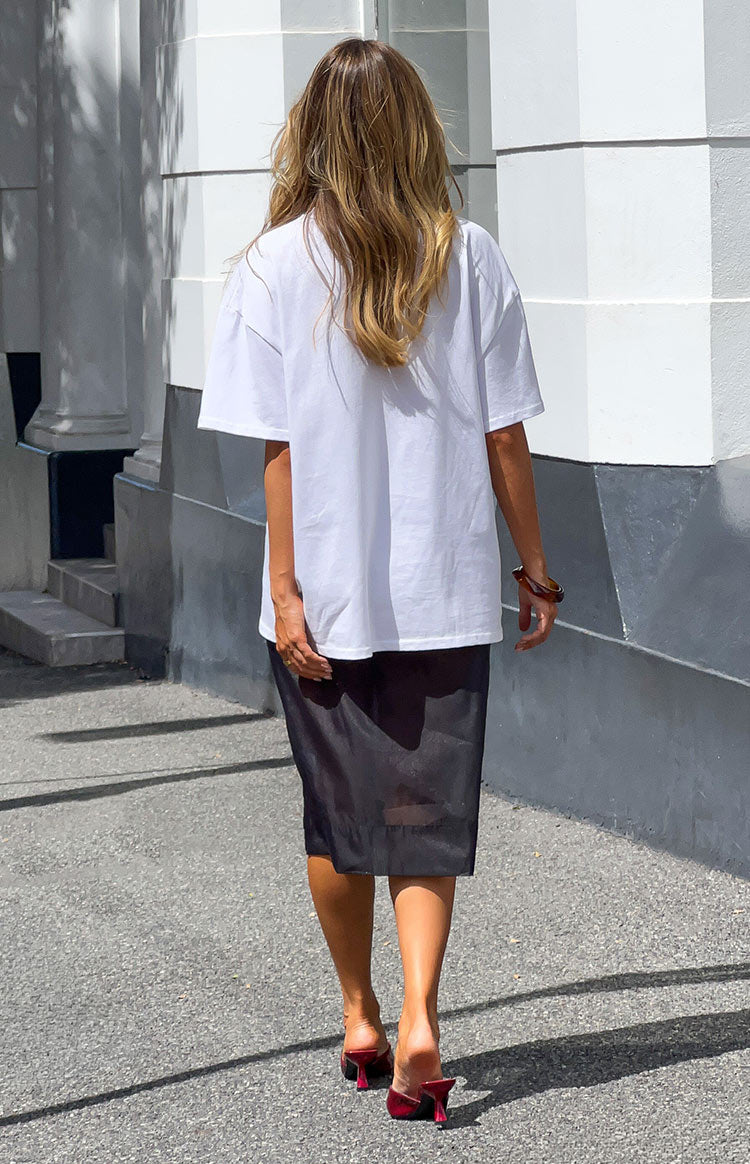 Rear view of a black organza sheer midi skirt with a straight, structured fit