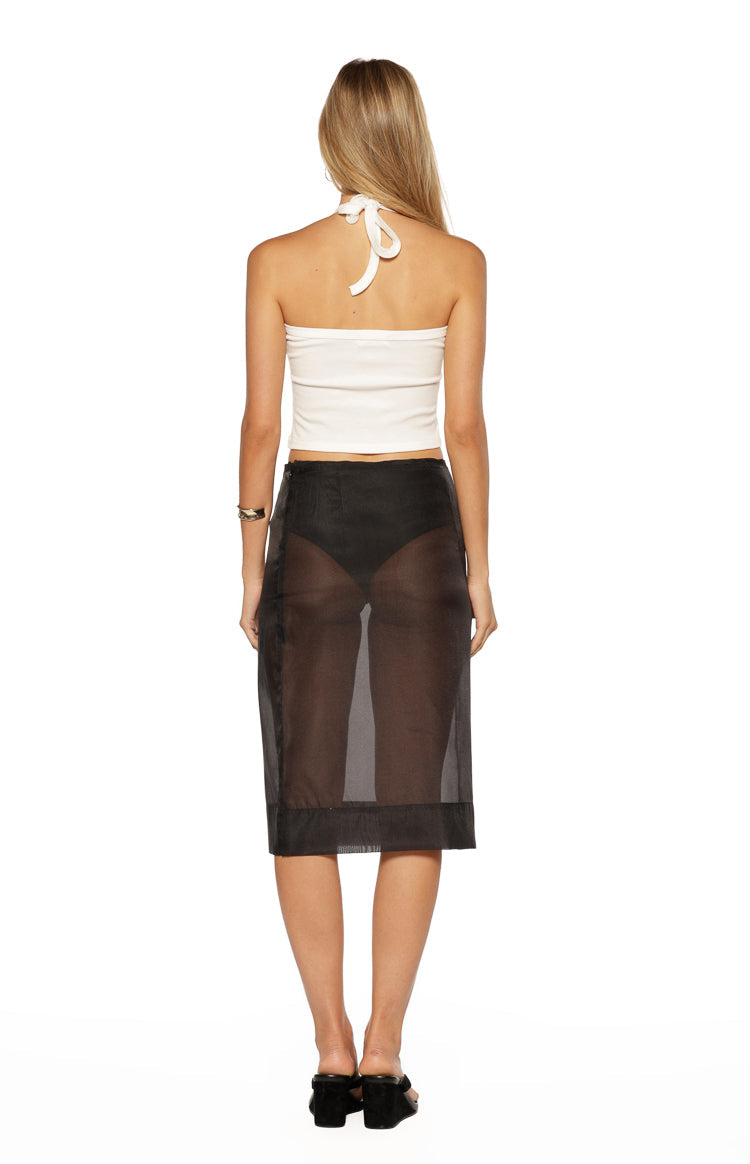 Rear view of the white tie-back halter neck crop top and black sheer organza midi skirt