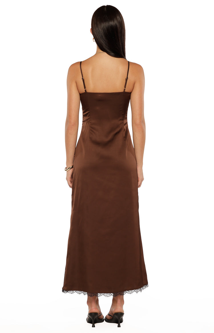 Rear view of a brown satin midi dress with thin adjustable spaghetti straps and black lace trim hem