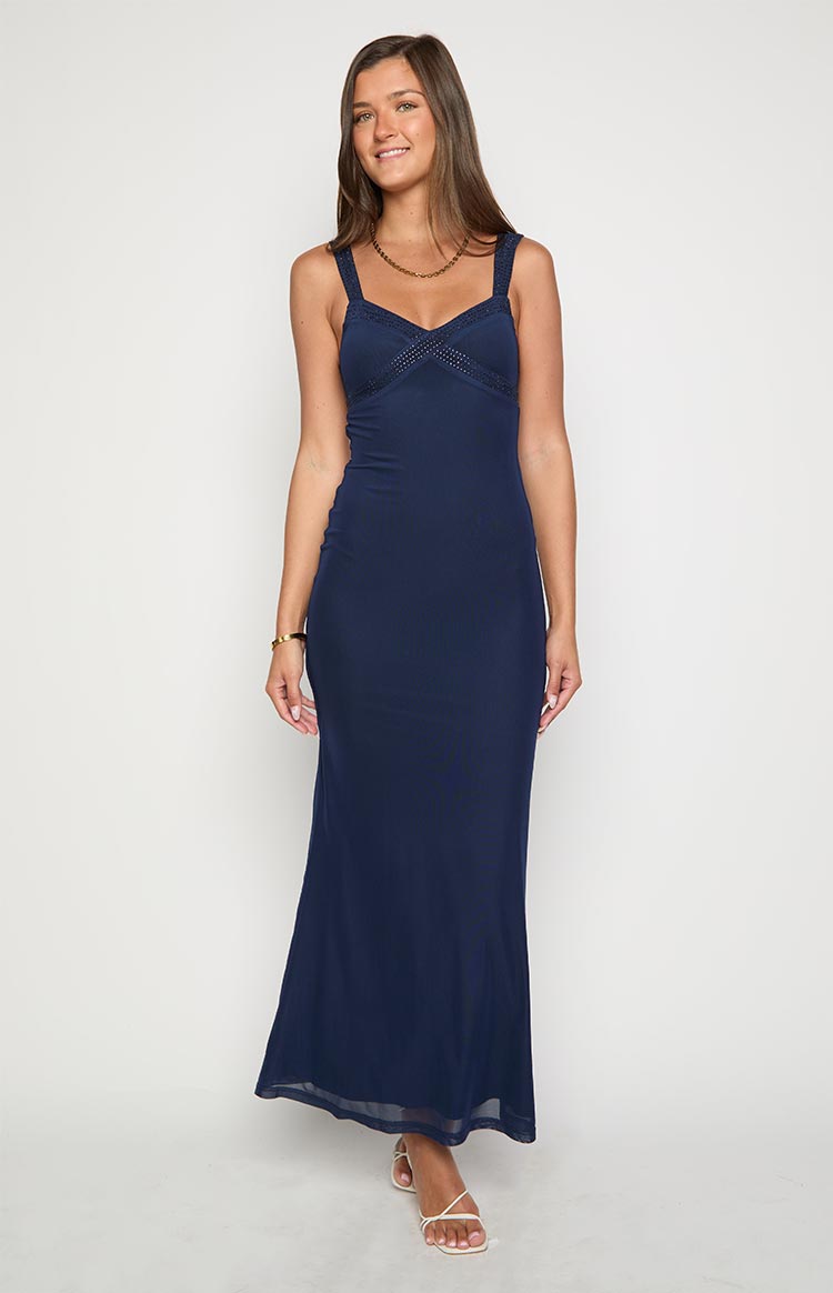 Navy mesh maxi dress with a V-neck bodice featuring delicate trim and wide straps, flowing to a sheer mesh hem