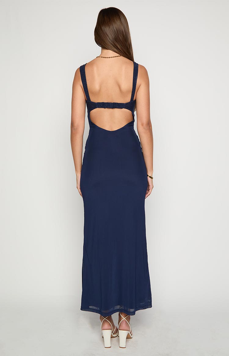 Rear view of a navy mesh maxi dress with a low back cutout, ruched elastic strap, and sheer mesh hem