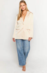 Relaxed cream satin blazer with a single button closure and contrasting trim on the flap pockets