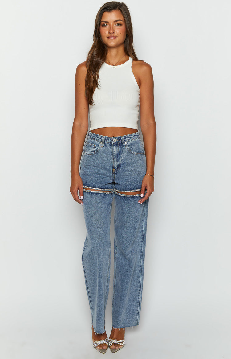Light blue wide leg denim jeans with diamante trim cutouts on the thighs and raw hems