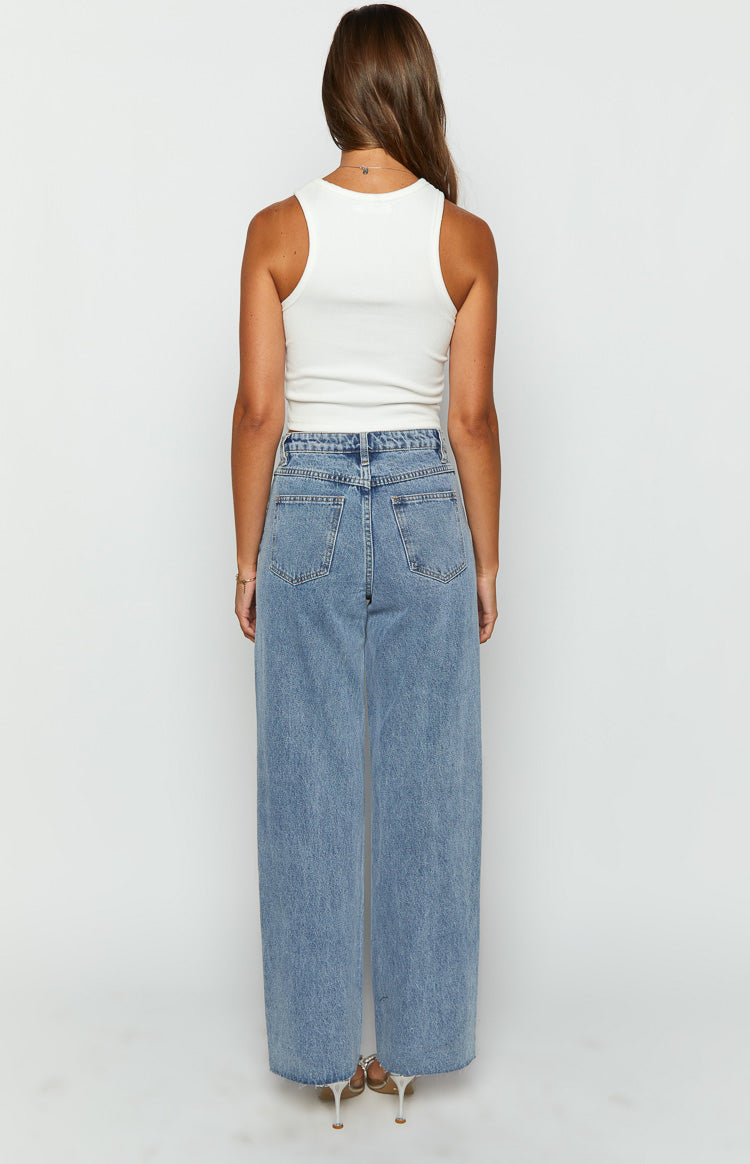 Rear view of light blue wide-leg denim jeans with back pockets and a high-waisted fit