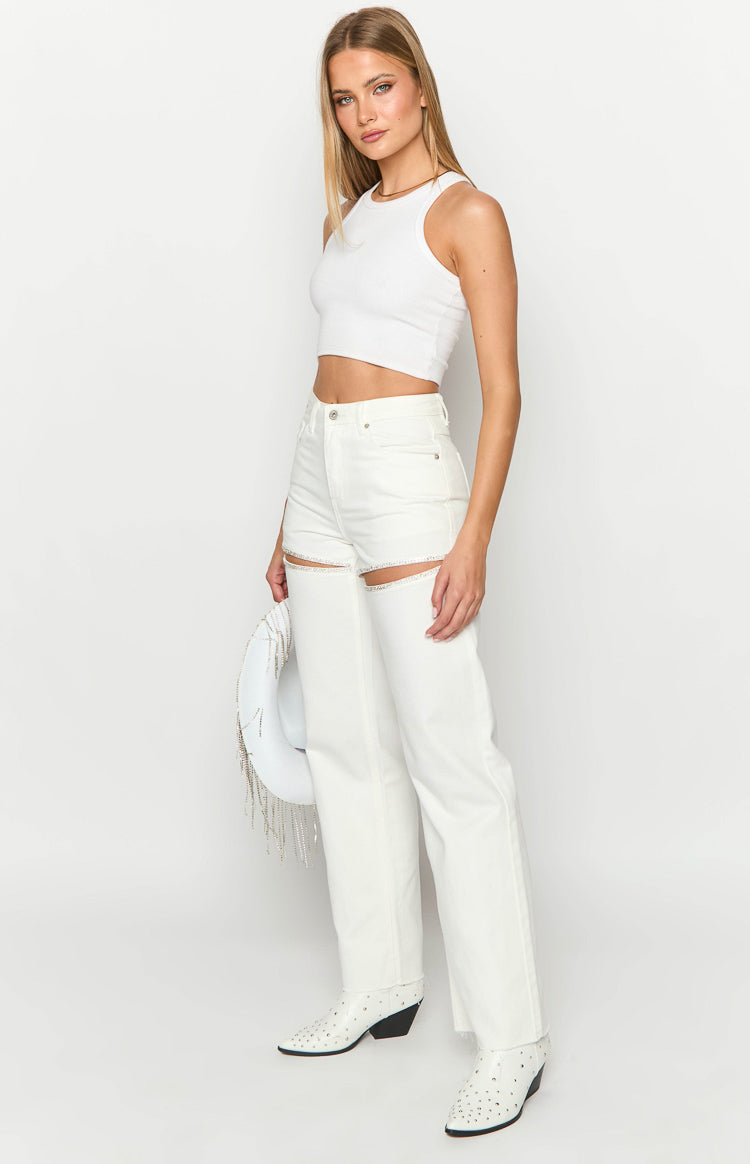Side view of white wide-leg denim jeans with diamante trim cutouts on the thighs