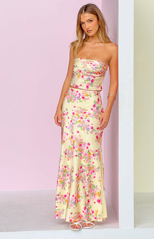 Yellow floral print maxi skirt with a flowy fit and vibrant pink and orange blooms