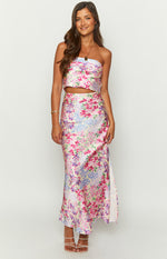 Front view of a pale yellow maxi skirt with a vibrant pink, purple, and blue floral print and a high side slit