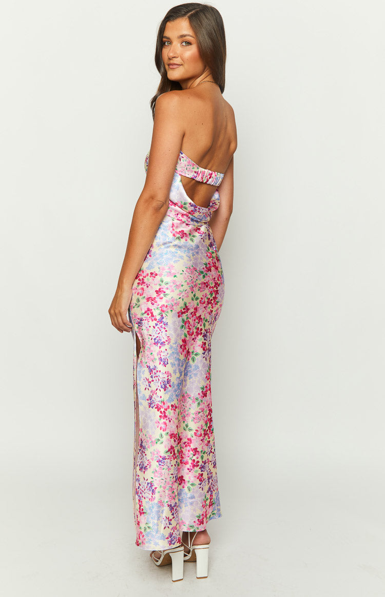Close-up of the vibrant floral print maxi skirt, showing the side zipper and waist cutout detail