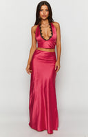 Side view of the pink satin maxi skirt, highlighting its smooth, flowing fabric and long, elegant drape