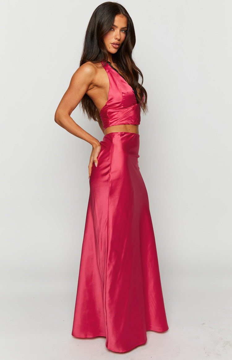 Close-up of the vibrant pink satin maxi skirt fabric, highlighting its smooth texture and soft drape