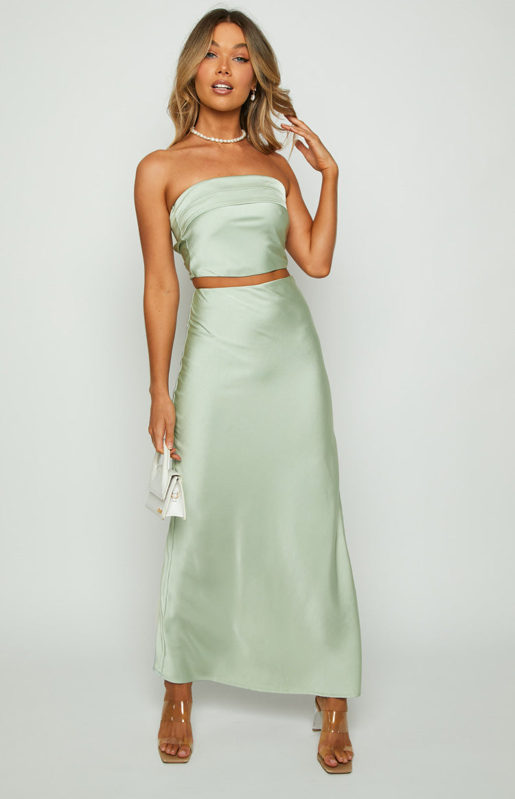 Full length view of a sage satin maxi skirt with a smooth, flowy A-line silhouette