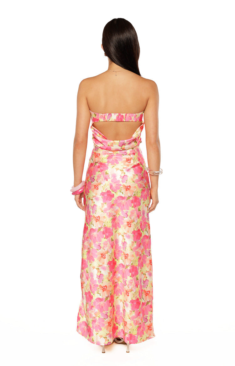Rear view of a yellow pink and orange floral print maxi skirt with a flowy silhouette