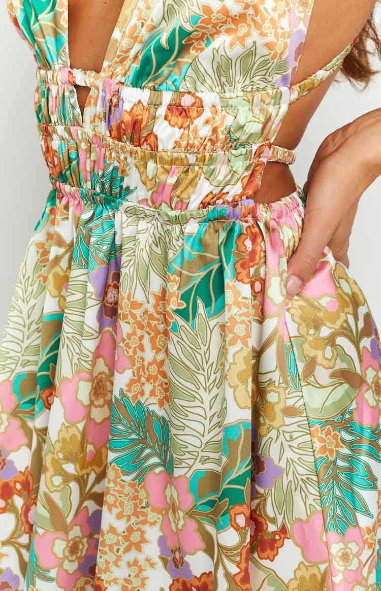 Rear view of the white tropical floral mini dress featuring a wide strap open back and elasticated waist cutouts