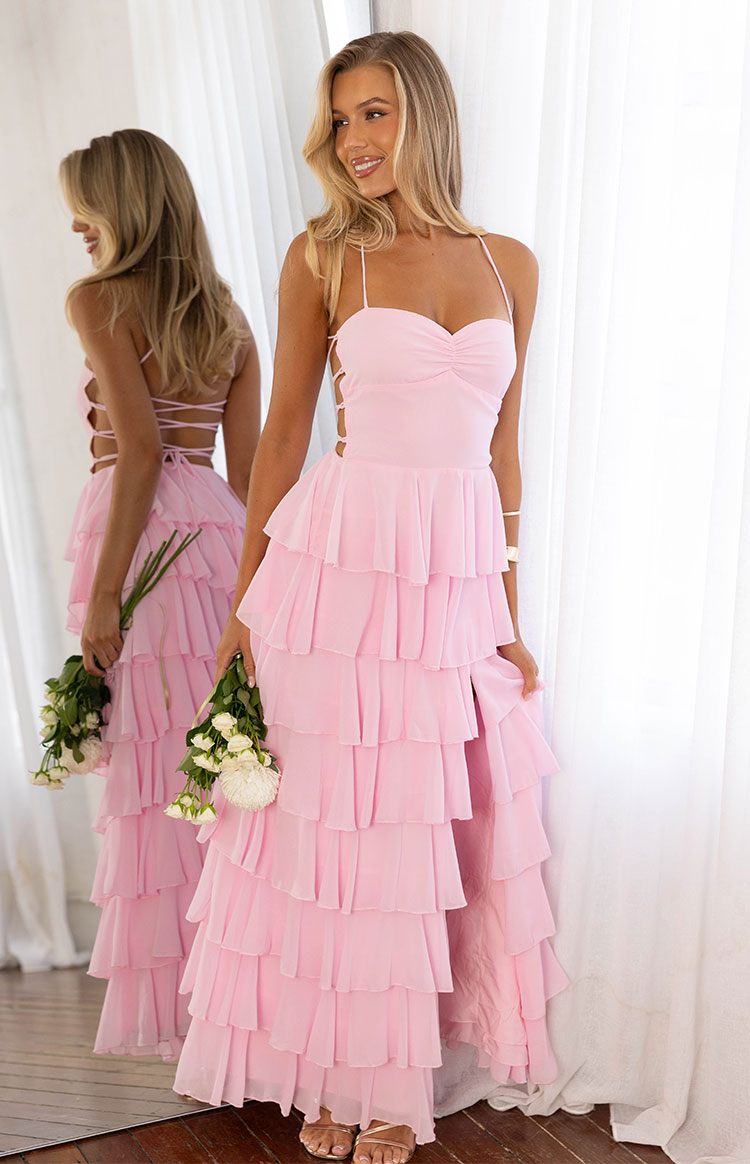 Pink tiered ruffle maxi dress with sweetheart neckline, side cutouts, and criss-cross back lacing