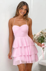 Pink mini dress with a ruched sweetheart neckline, thin spaghetti straps, and a tiered ruffle skirt