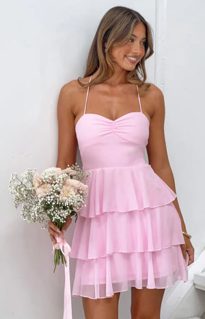 Pink mini dress with a ruched sweetheart bust and three-tiered sheer ruffle skirt