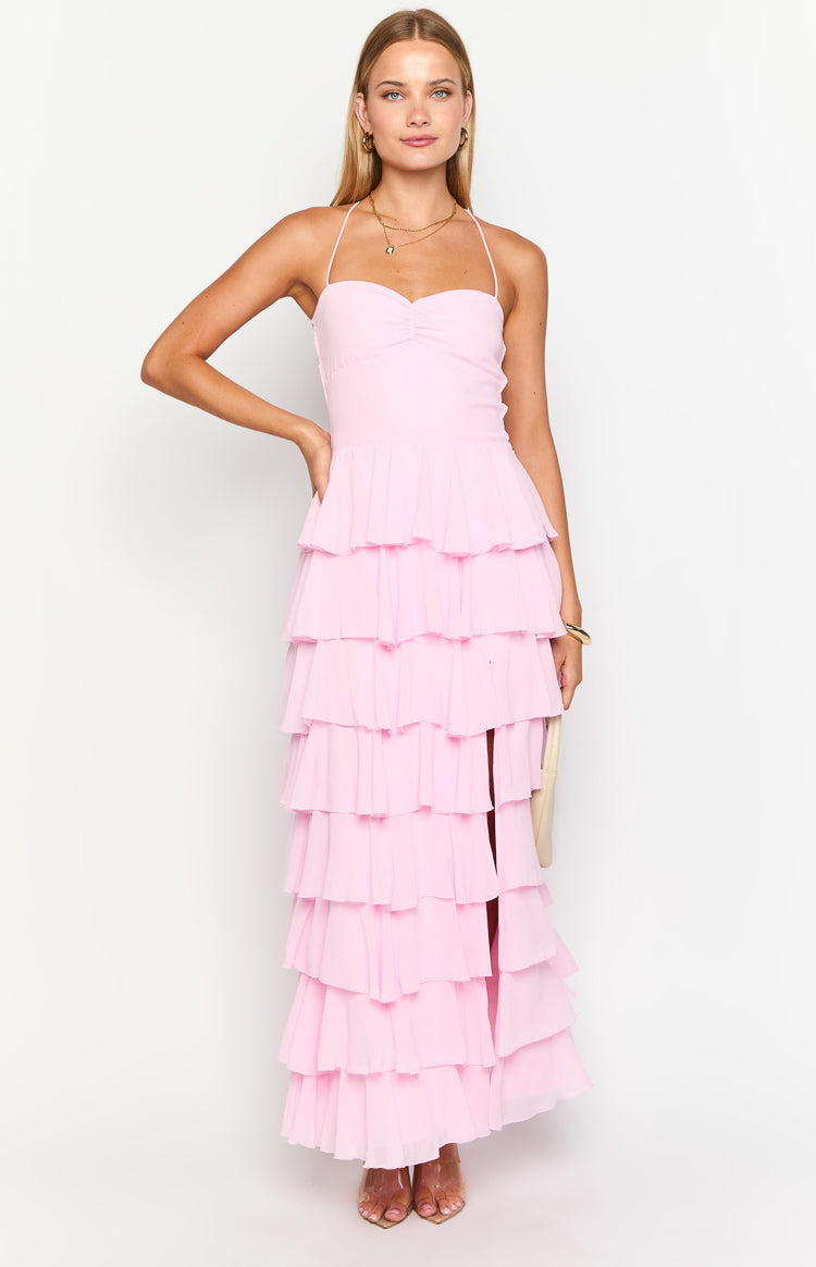 Full length front view of a pink tiered ruffle maxi dress with a ruched sweetheart halter neckline and side slit