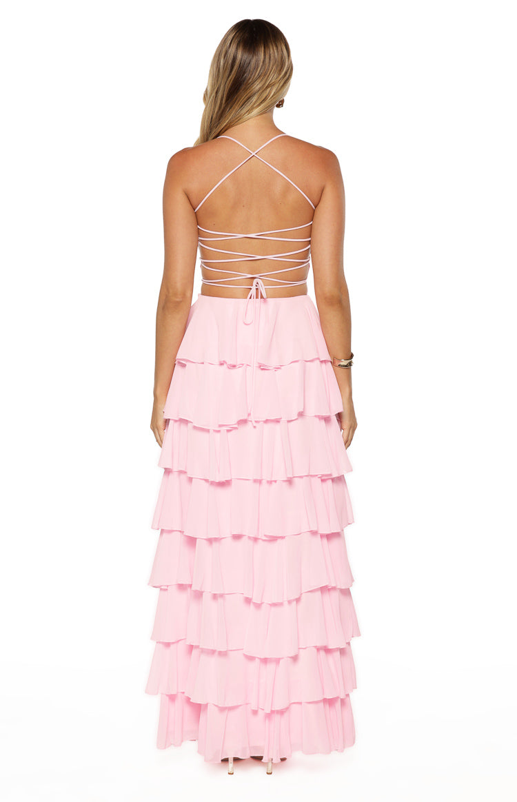 Back view of a pink maxi dress with a criss-cross lace-up back and a tiered ruffle skirt