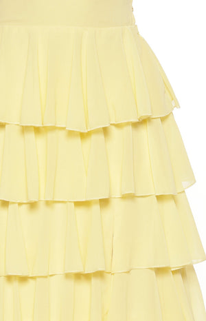 Close-up of the tiered ruffles on the skirt of the yellow maxi dress