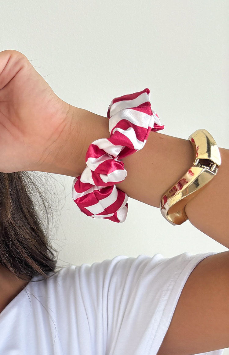 Red and white striped satin scrunchie with a gathered, ruffled texture