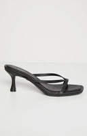 A single black heeled sandal with thin straps is shown on a light background. The sandal has a square toe and a small