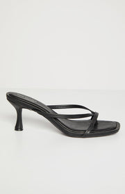 Side view of black kitten heels featuring a slender flared kitten heel and square toe