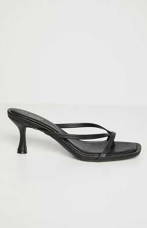 Side view of black kitten heels featuring a slender flared kitten heel and square toe