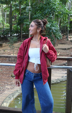 Mid wash denim low rise jeans with a relaxed wide leg fit and visible button closure