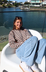 Chocolate and white horizontal stripe long sleeve top with a crew neck and relaxed fit